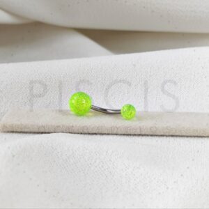 Piercing ombligo bolitas acrílicas amarillas con glitter.
